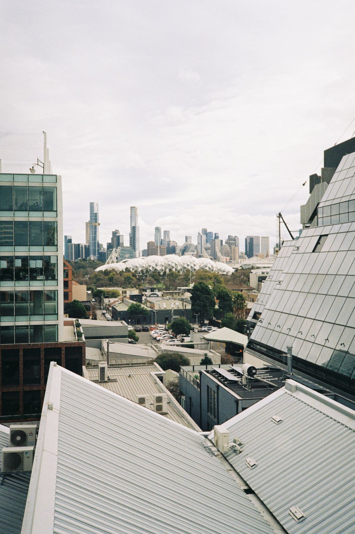 Rooftop Skyline showing the AAMI Park stadium between two other buildings.